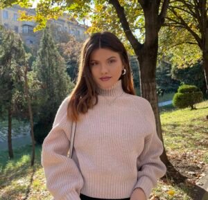 Ms.Erletë, a music teacher, posing in nature